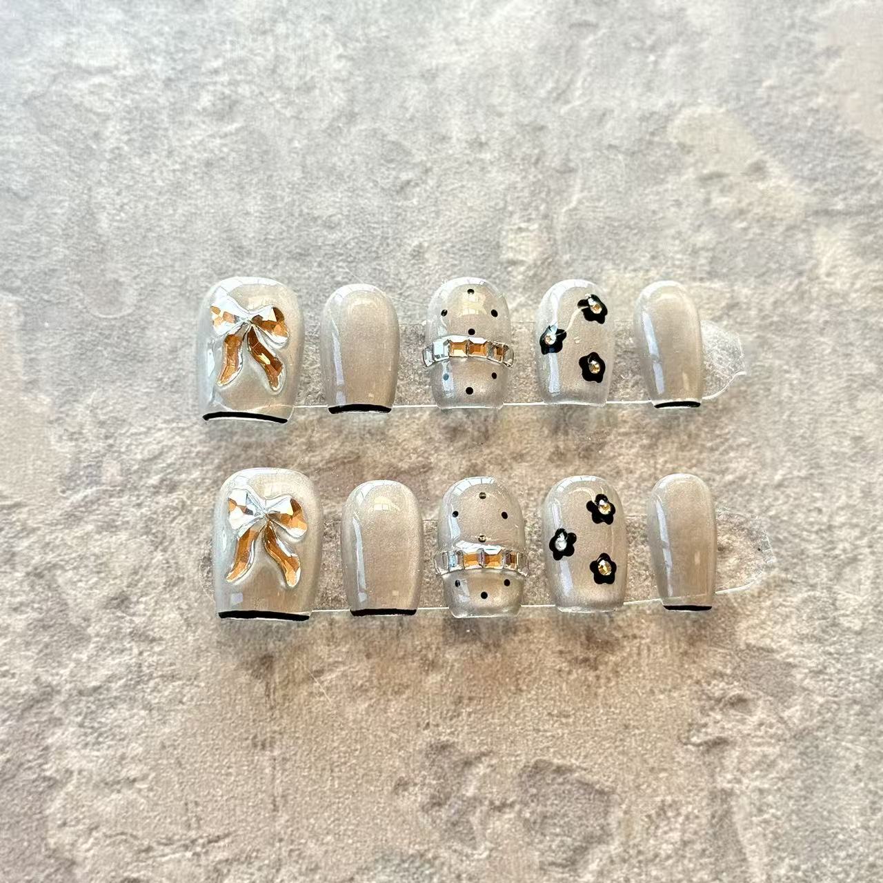 Noir Bow – Grey Sheer Luxury Press-On Nails with 3D Gold Ribbon & Floral Accents – Short Squoval Shape