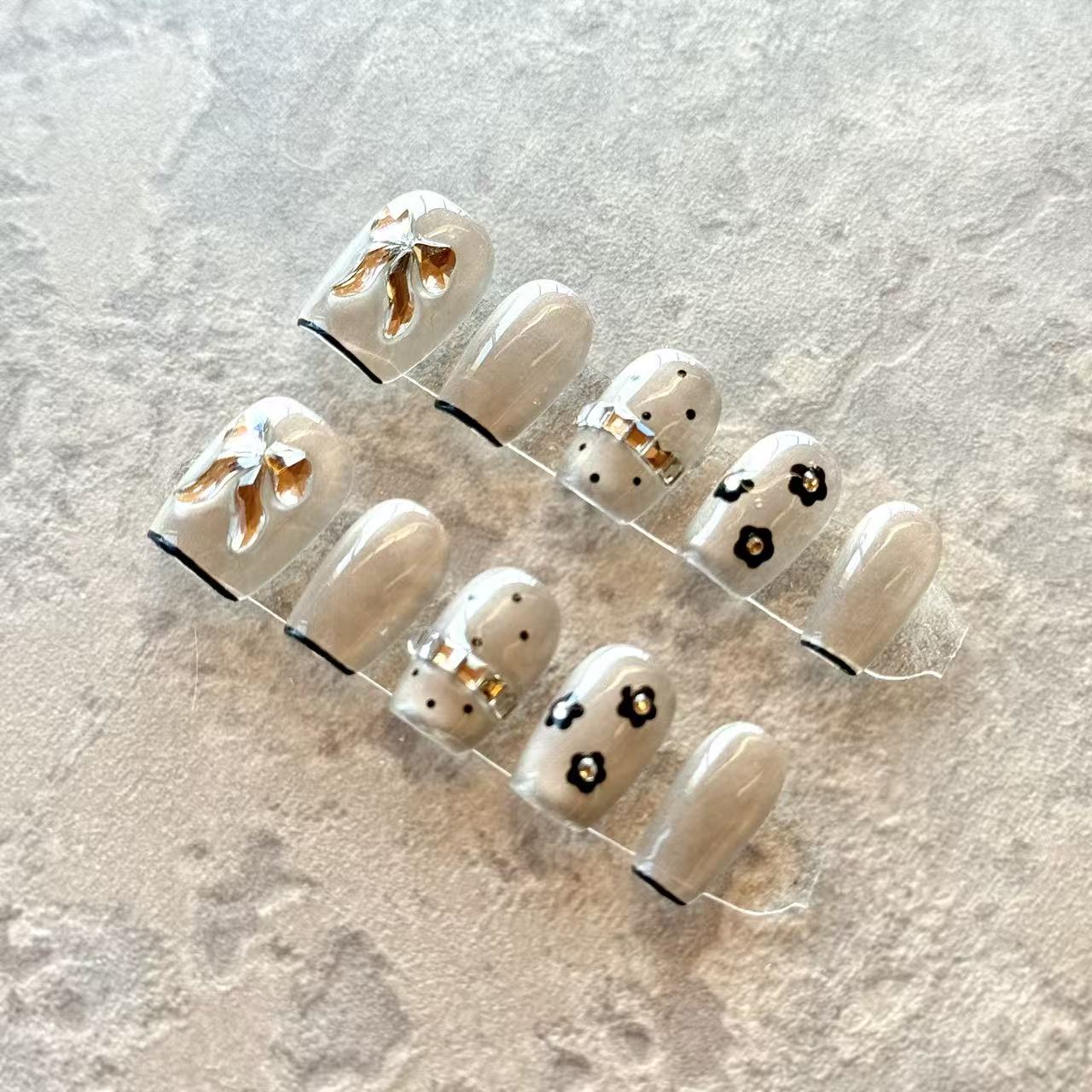 Noir Bow – Grey Sheer Luxury Press-On Nails with 3D Gold Ribbon & Floral Accents – Short Squoval Shape