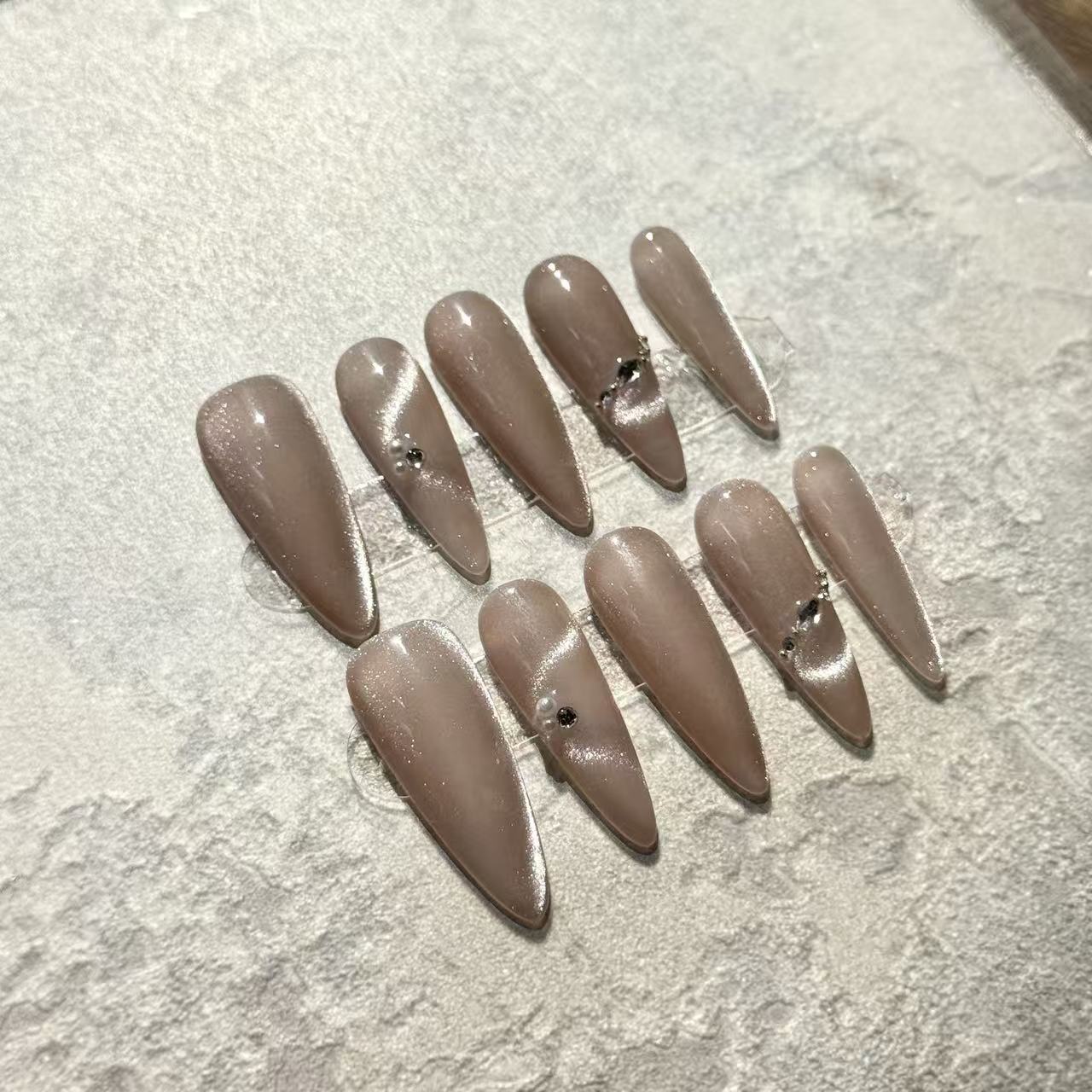 Pearl Nude Elegance – Stiletto Press-On Nails with Nude Cat-Eye Shine & Minimalist Gem Accents