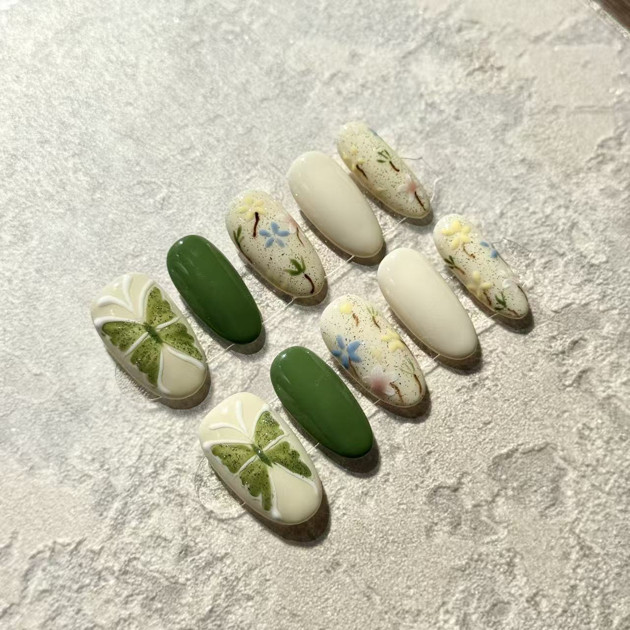 Spring Garden – Oval Press-On Nails with Green Clover, Floral Hand-Paint & Pastel Accents