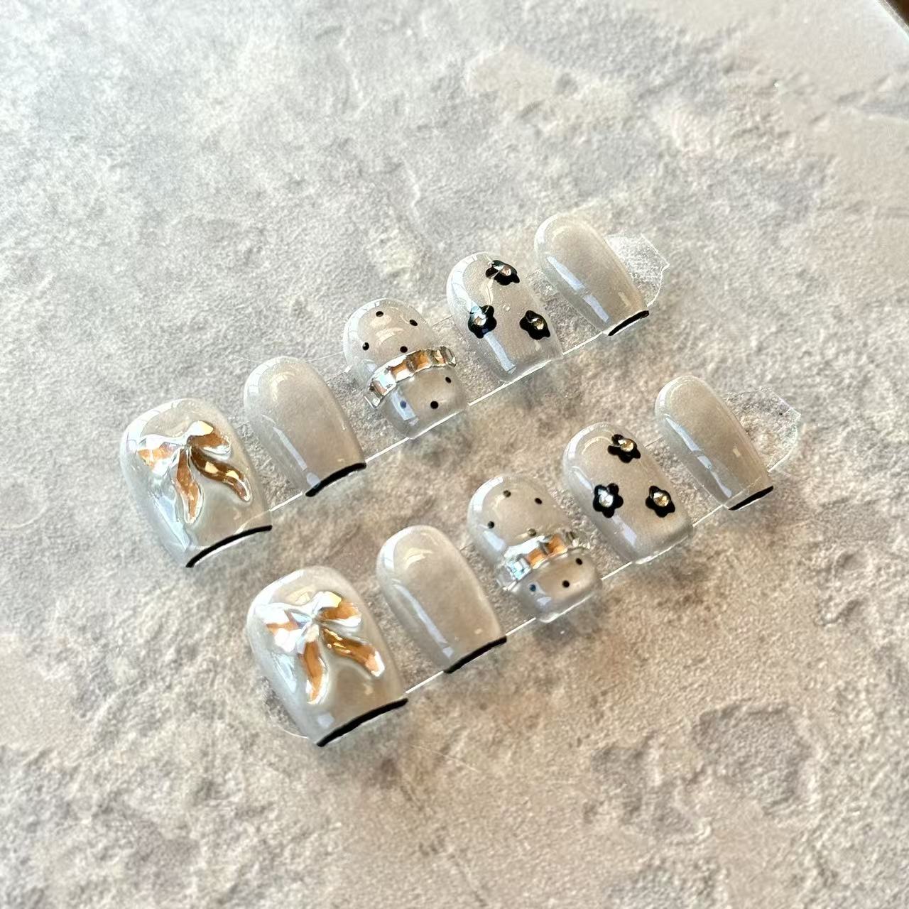 Noir Bow – Grey Sheer Luxury Press-On Nails with 3D Gold Ribbon & Floral Accents – Short Squoval Shape